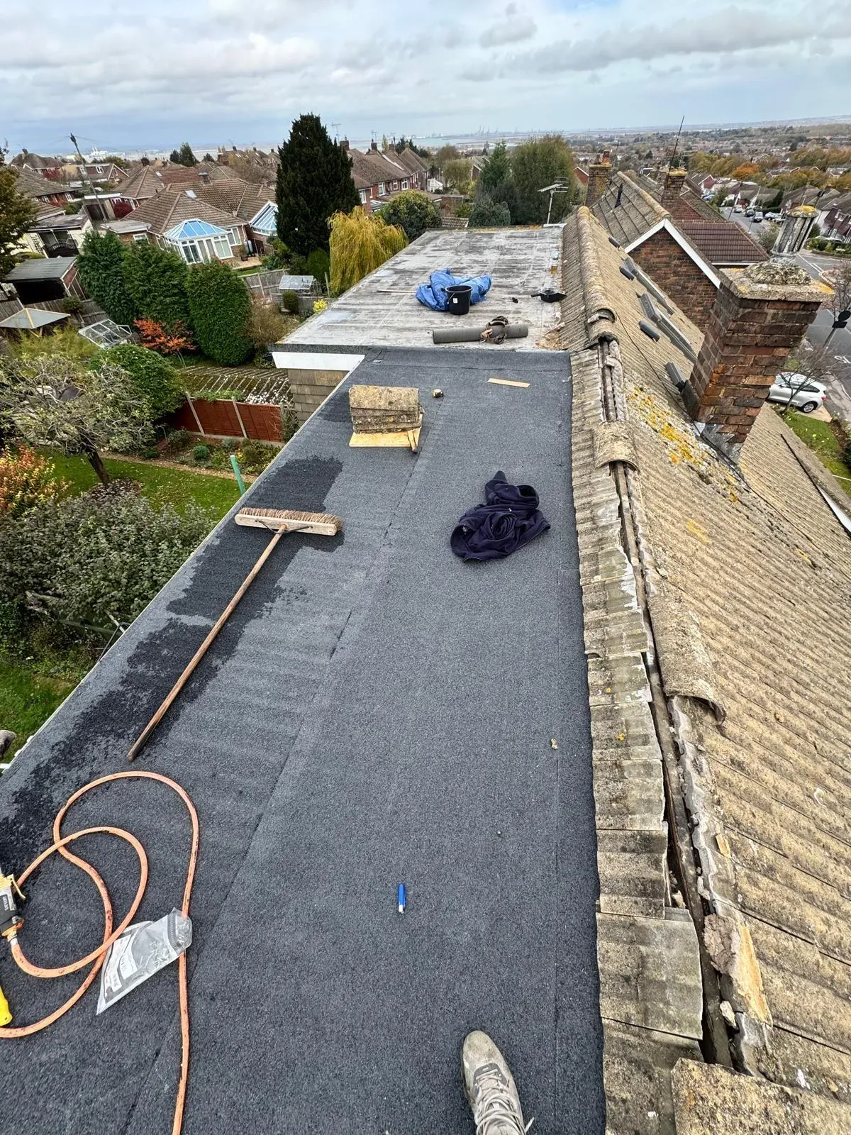 Expert felt roofing installation in progress by First Choice Roofing Kent, showing high-quality flat roof membranes being applied.