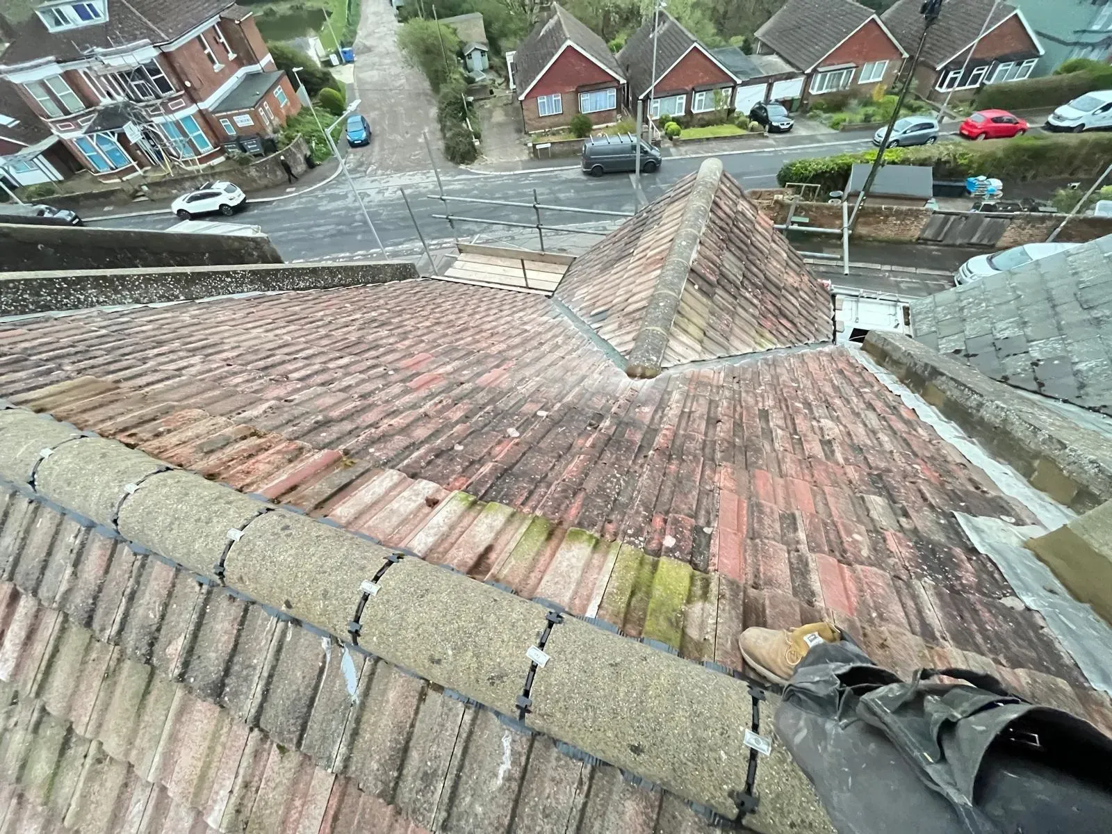Professional dry ridge system installation on a tiled roof in West Malling, Kent, with scaffolding in place.