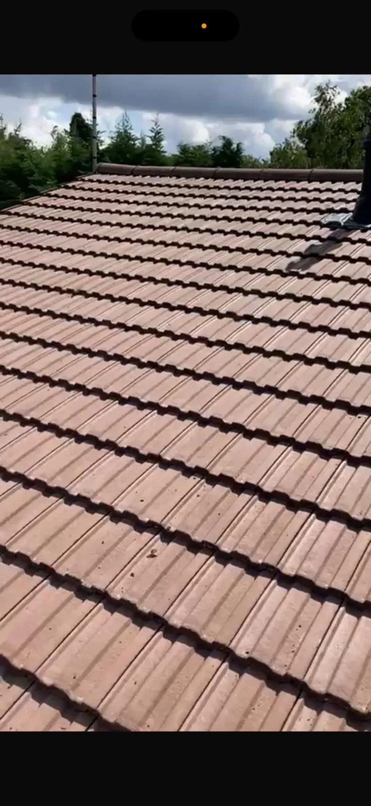 Newly installed brown interlocking roof tiles on a pitched roof in West Malling, Kent.