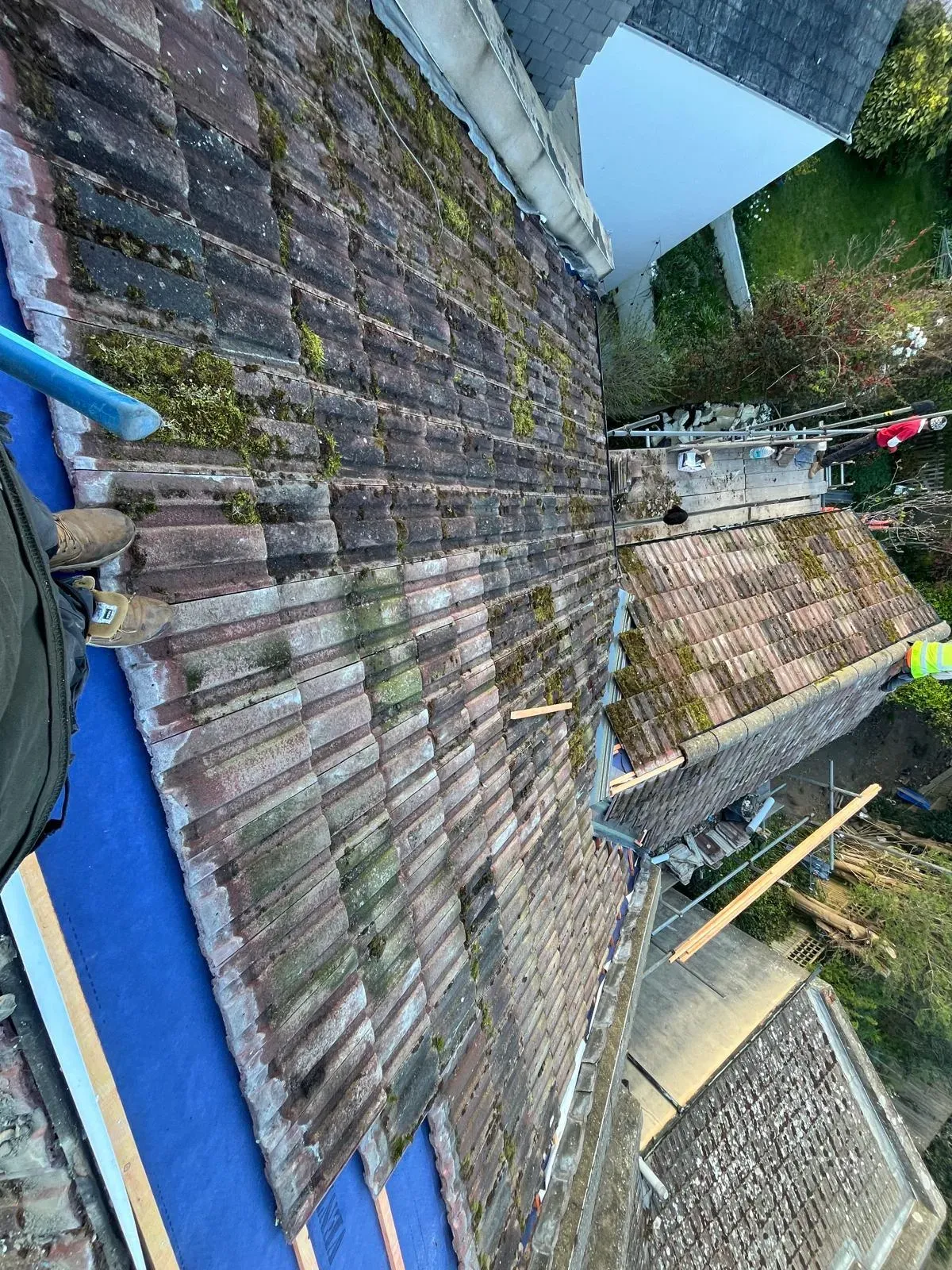 First Choice Roofing Kent team performing a full re-roofing and roof replacement on a residential property in Kent, showing the transition from old tiles to new underlay.