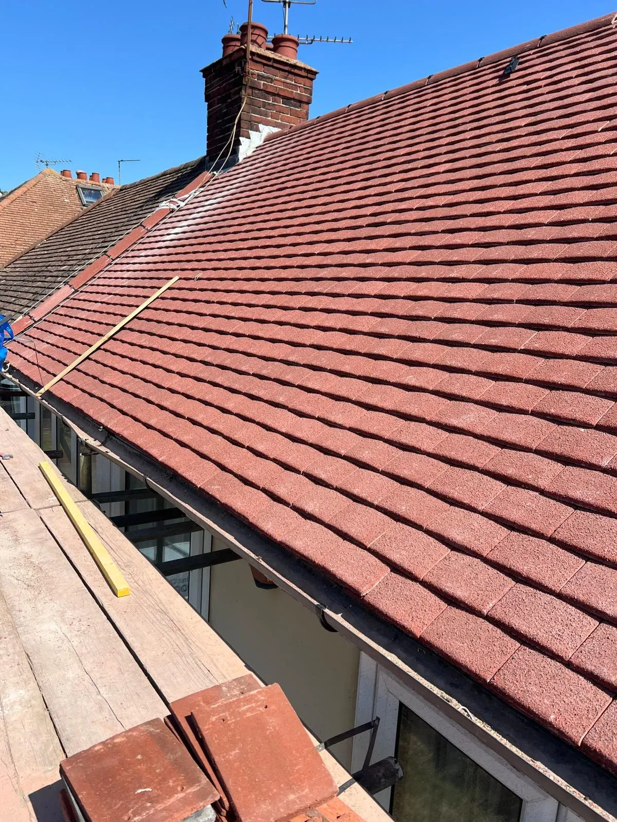 New tiled roof installation in West Malling Kent with red roof tiles and scaffolding.