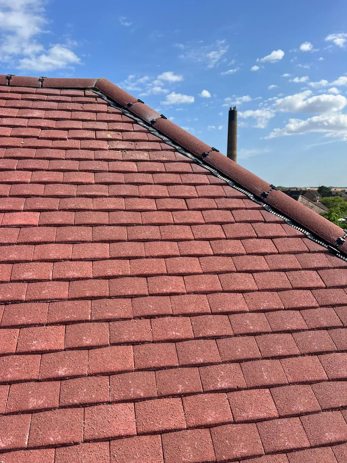 A red tiled roof with a newly installed dry ridge system by First Choice Roofing Kent.