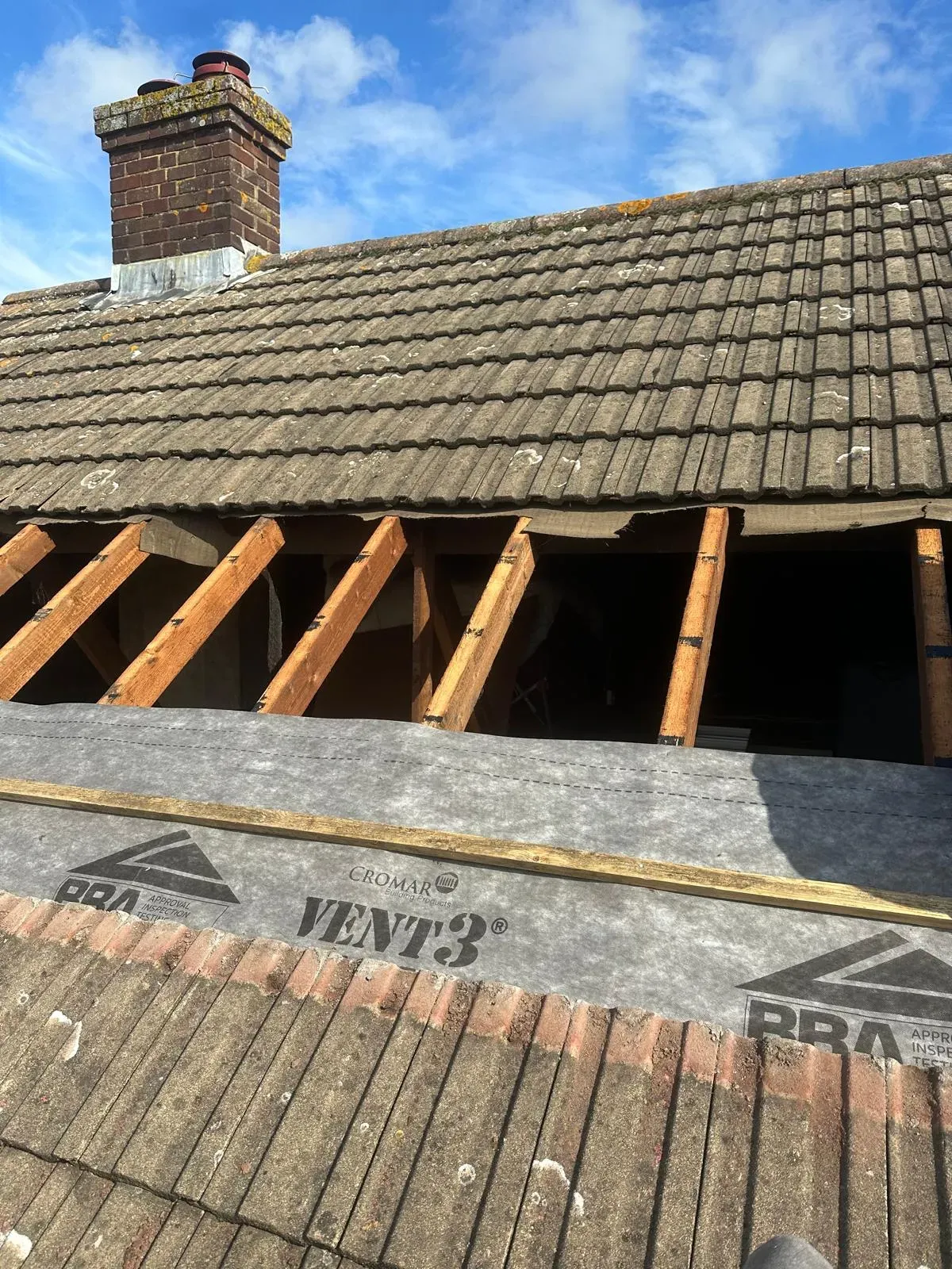 Professional re-roofing and membrane installation in West Malling showing exposed rafters and breathable underlay.
